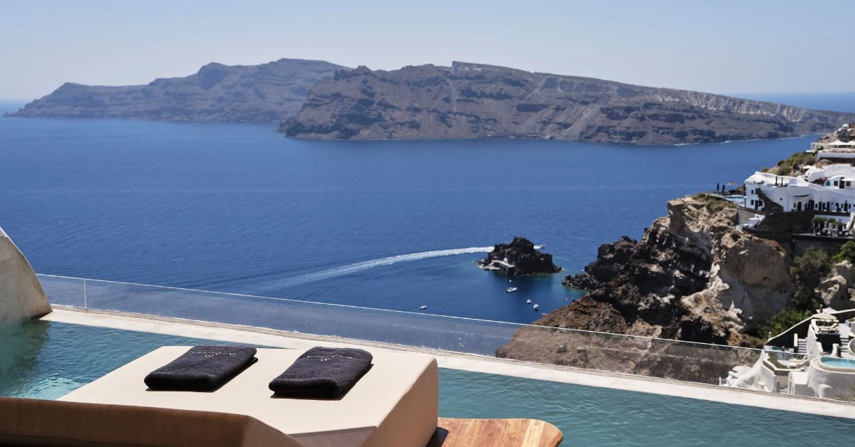 Sunset view over a private Mediterranean villa terrace with infinity pool overlooking the sea, representing the rise of seasonal living among ultra-wealthy travelers.